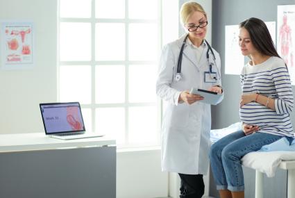 Pregnant woman meeting with her doctor