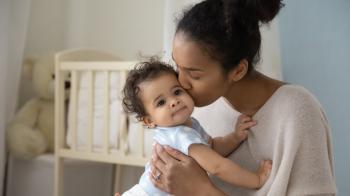 Mother kissing child's cheek