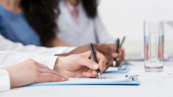 Person taking notes on a clipboard