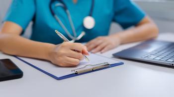 healthcare worker writing on clipboard