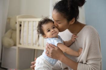 Mother kissing child's cheek